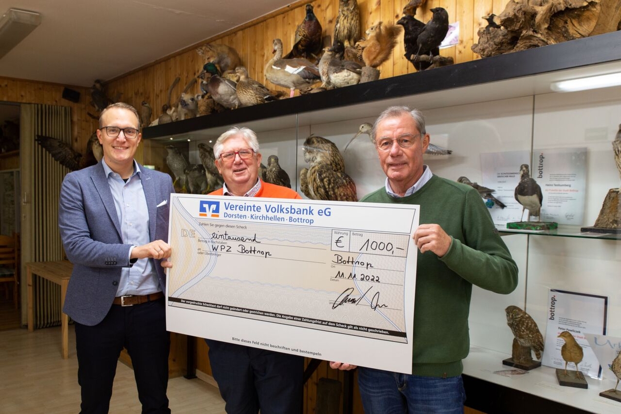 Sebastian Offel von der Vereinten Volksbank überreicht den Vorsitzenden Peter Pawliczek und Hubert Schulte einen Scheck.