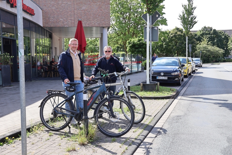 Bezirksbürgermeister Hendrik Dierichs und Passant Willi Henning tauschen sich über den Nutzen der neuen Fahrradstellplätze vor Rossmann und Sporkmann aus.